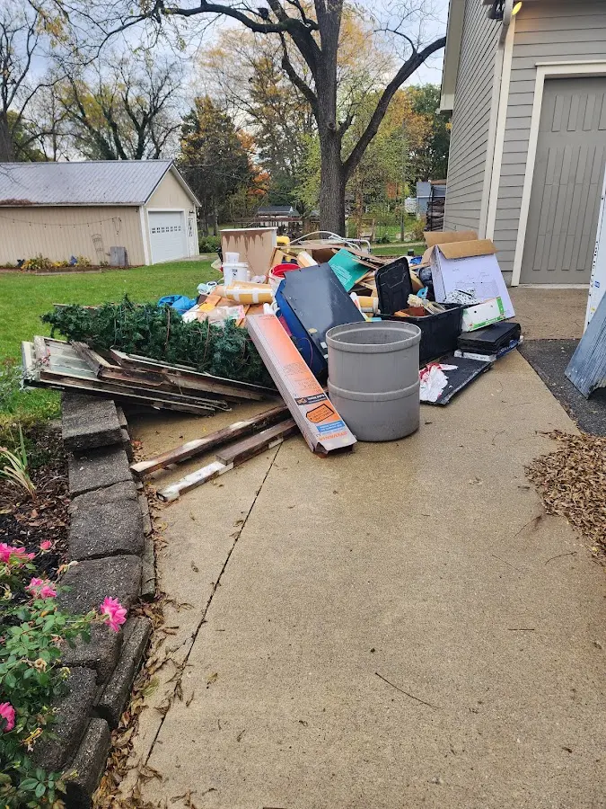 Dumpster being loaded with debris for Estate Cleanout Dumpster Rental in Newport